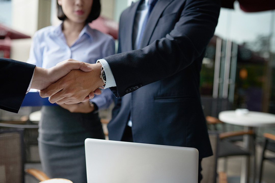 Two business people shaking hands